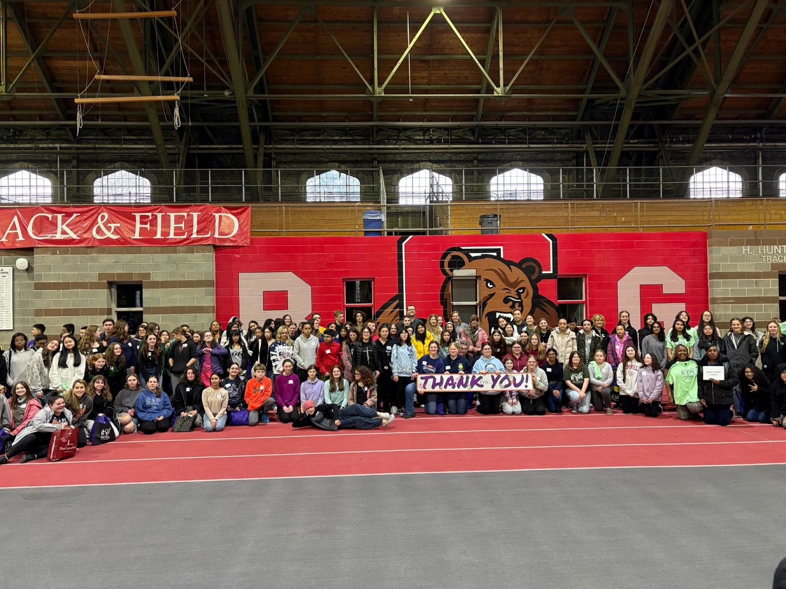 Large group photo of EYH 2025 participants smiling with a banner that says "THANK YOU"
