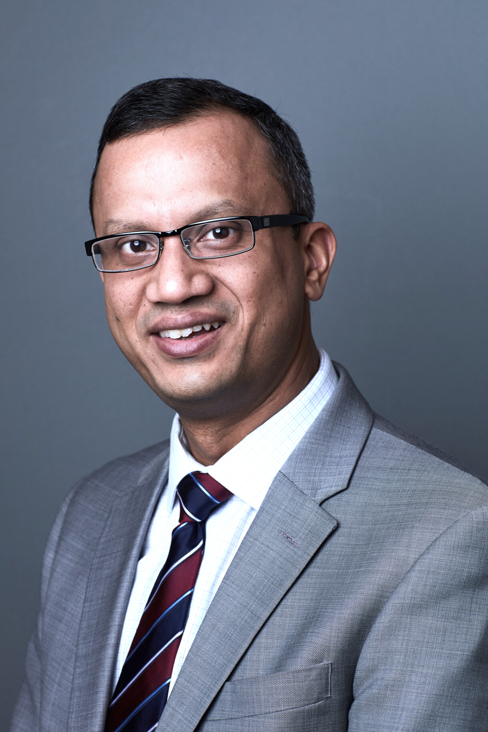 Portrait photograph of Dr. Jyotishman Pathak smiling at the camera