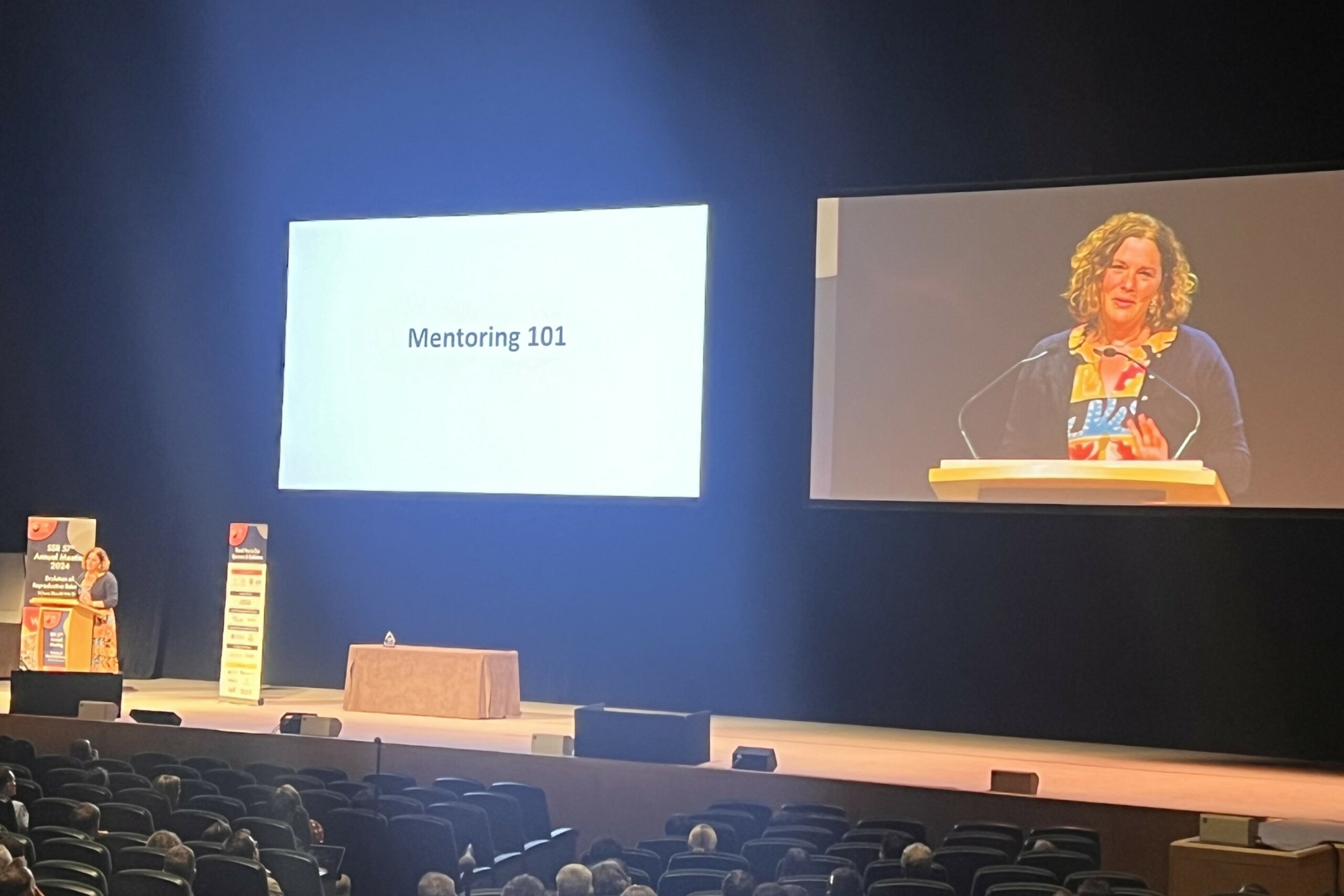 Dr. Paula Cohen receiving the SSR Trainee Mentoring Award onstage at the 2024 SSR Conference