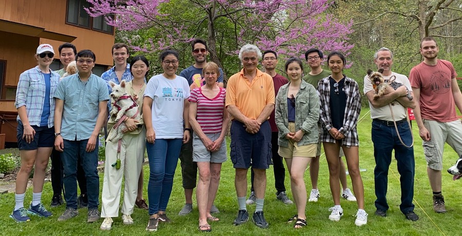 Members of the Schimenti lab in a group photograph, standing in a lawn